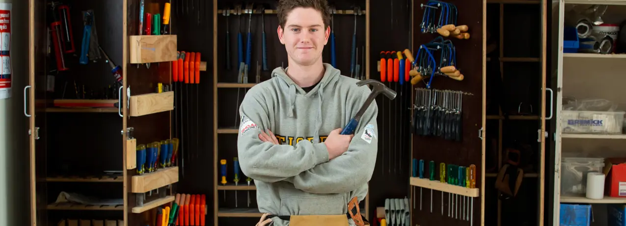 SWTAFE student in front of a tool cupboard