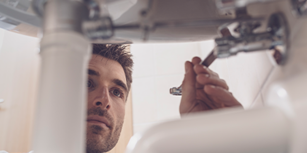 plumber working on sink