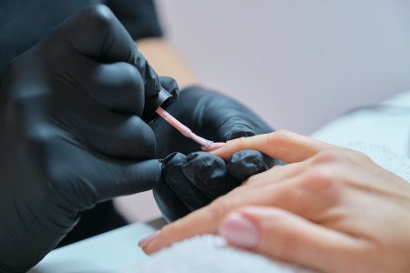 Beautician painting nails