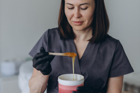 Beautician using hot wax